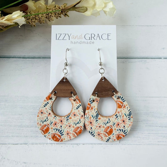 A pair of teardrop-shaped dangle earrings displayed on a white card labeled 'IZZYand.GRACE handmade.